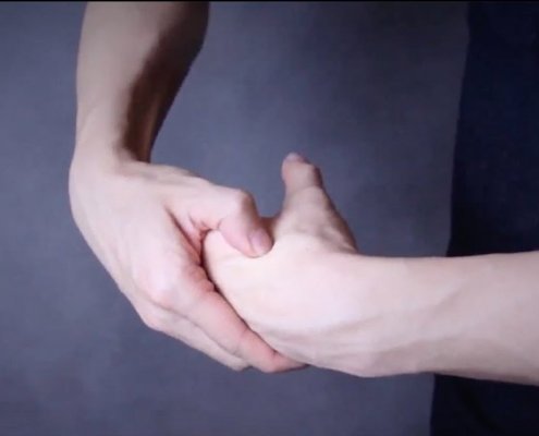 two hands, performing acupressure