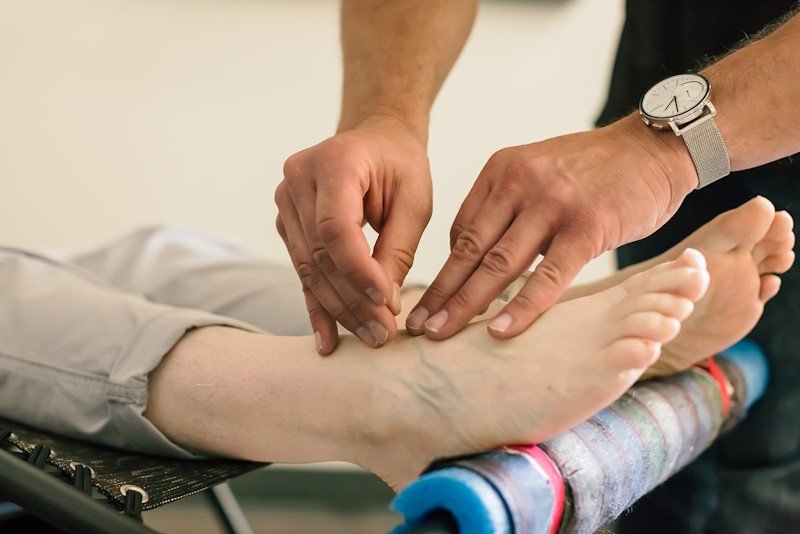 accupuncture-therapy-hero Giving acupuncture on feet